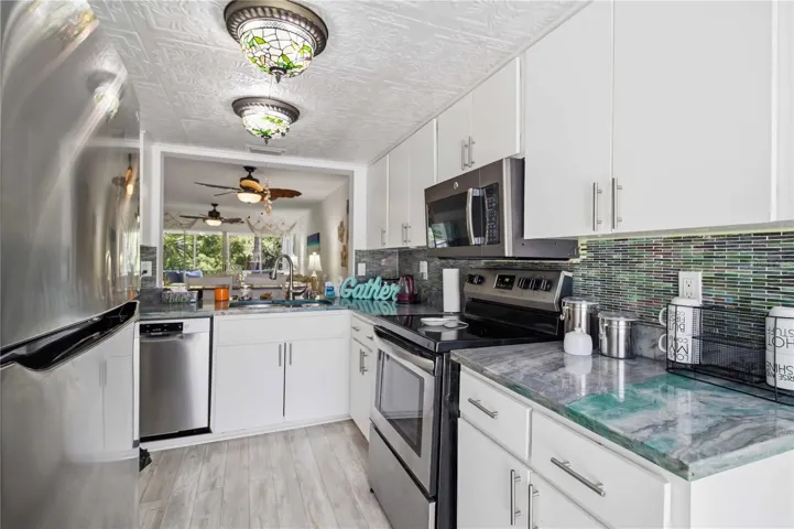 Passthrough from kitchen into open Dining / Living Room combo