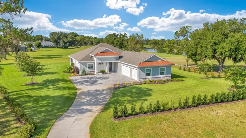Luxury custom home on over one acre in Cypresswood Golf &amp; Country Club with expansive golf course views, circular driveway, and exceptional curb appeal in Winter Haven, Florida.