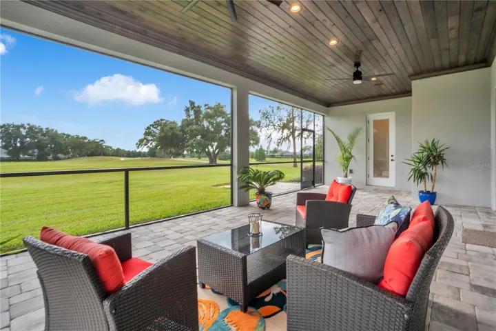 Outdoor living area designed for entertaining and relaxation, offering unobstructed views of the beautifully maintained golf course.