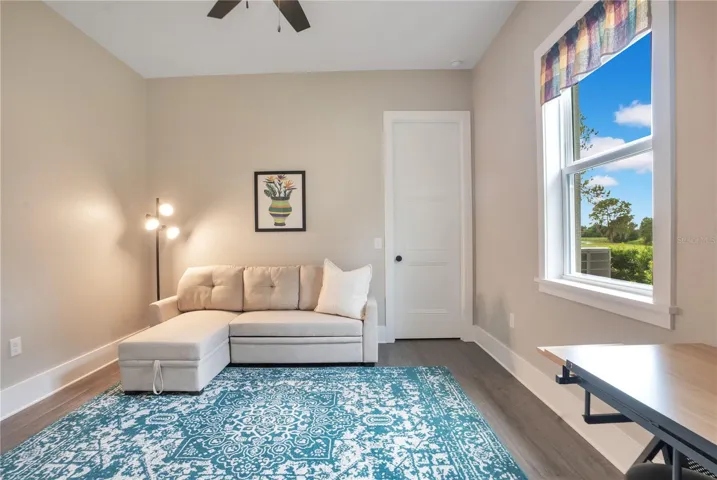 Comfortable fourth bedroom great for living area offering flexible space for relaxation, entertainment, or guest use.