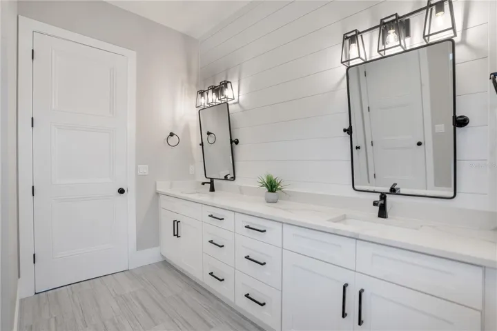 Expansive owner's bathroom with dual-sink vanity, custom cabinetry, and premium finishes designed for modern luxury living.