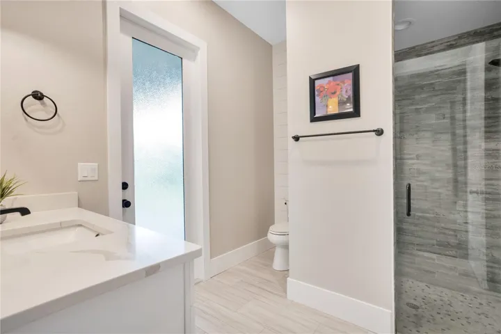 Guest bathroom featuring walk-in shower, and contemporary finishes designed for comfort and functionality.