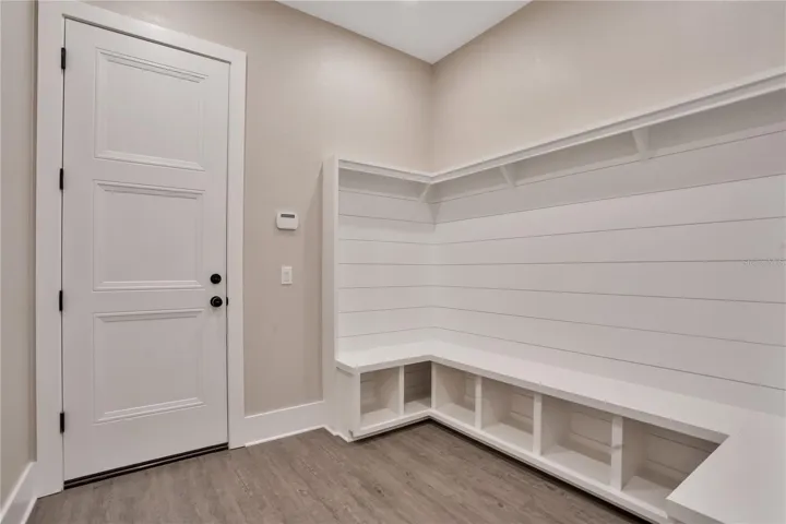 Custom mudroom with built-in storage, bench seating, and organizational space designed for everyday convenience and functionality.