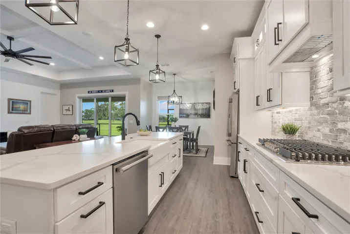 Large gourmet kitchen featuring extensive counter space, premium finishes, natural gas cooking, and seamless flow to the great room.