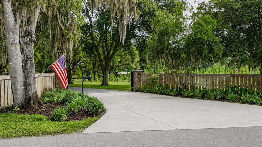 Stately oak-lined drive leads to a secure electric gated entrance.