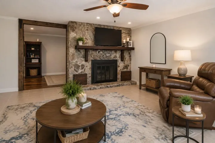 Cozy living room centered around a stunning stone fireplace.