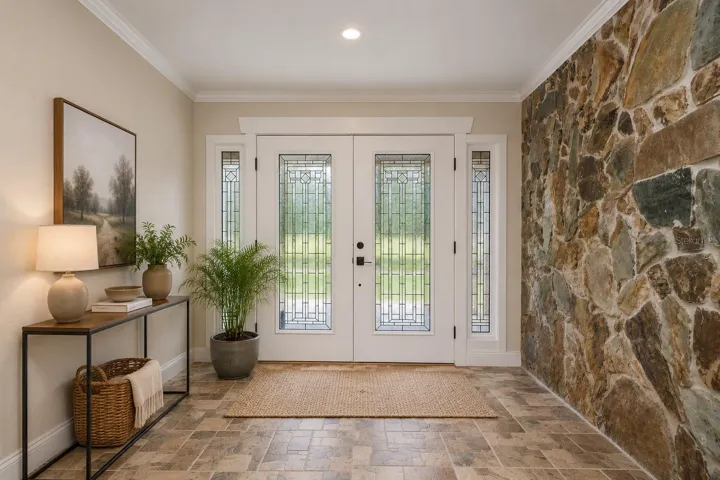 Grand foyer welcomes guests through stunning double glass doors.