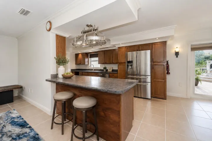 Kitchen designed for gathering, complete with breakfast bar seating.