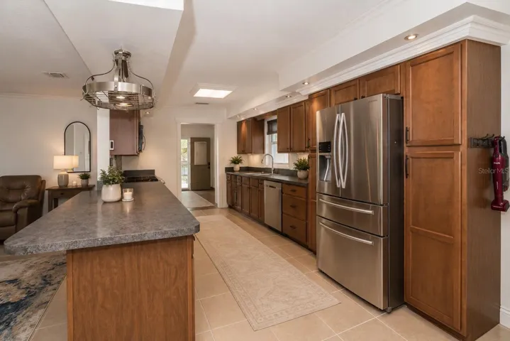 Well-appointed kitchen offering wood cabinetry and stainless steel finishes.