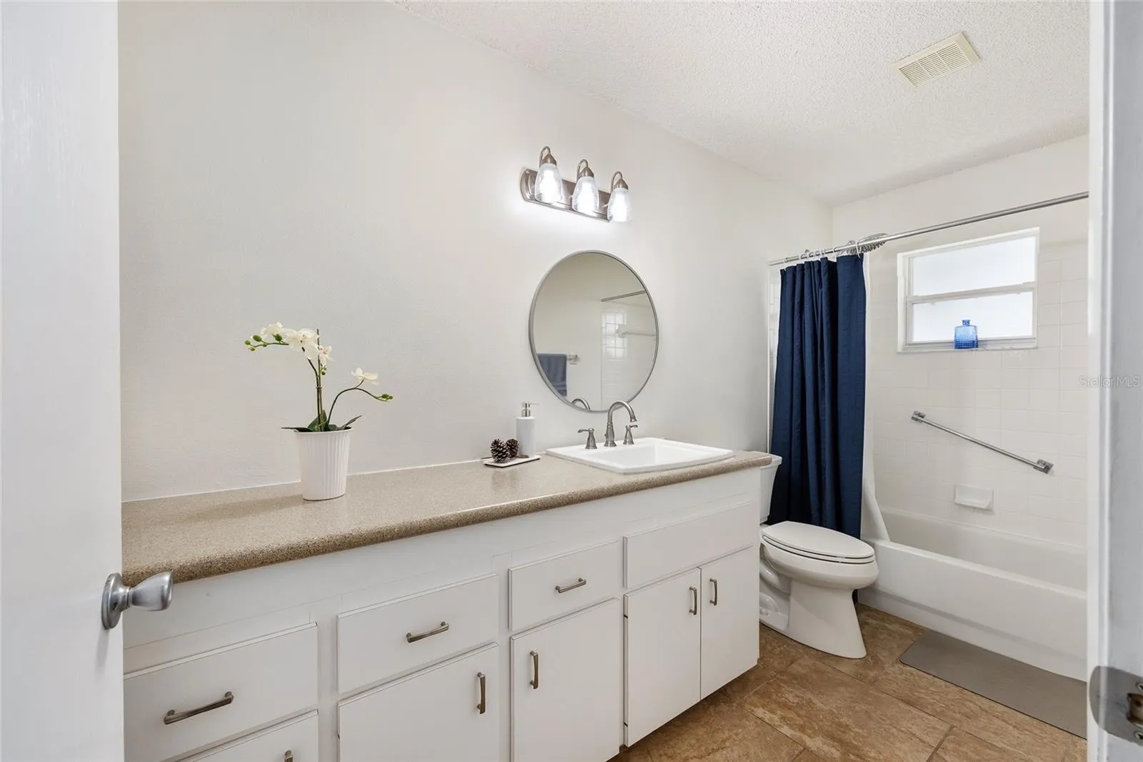 Guest ensuite with sliding barn door creates a true guest suite feel, ideal for long-term guests, multi-generational living, or anyone needing a private suite-style layout.