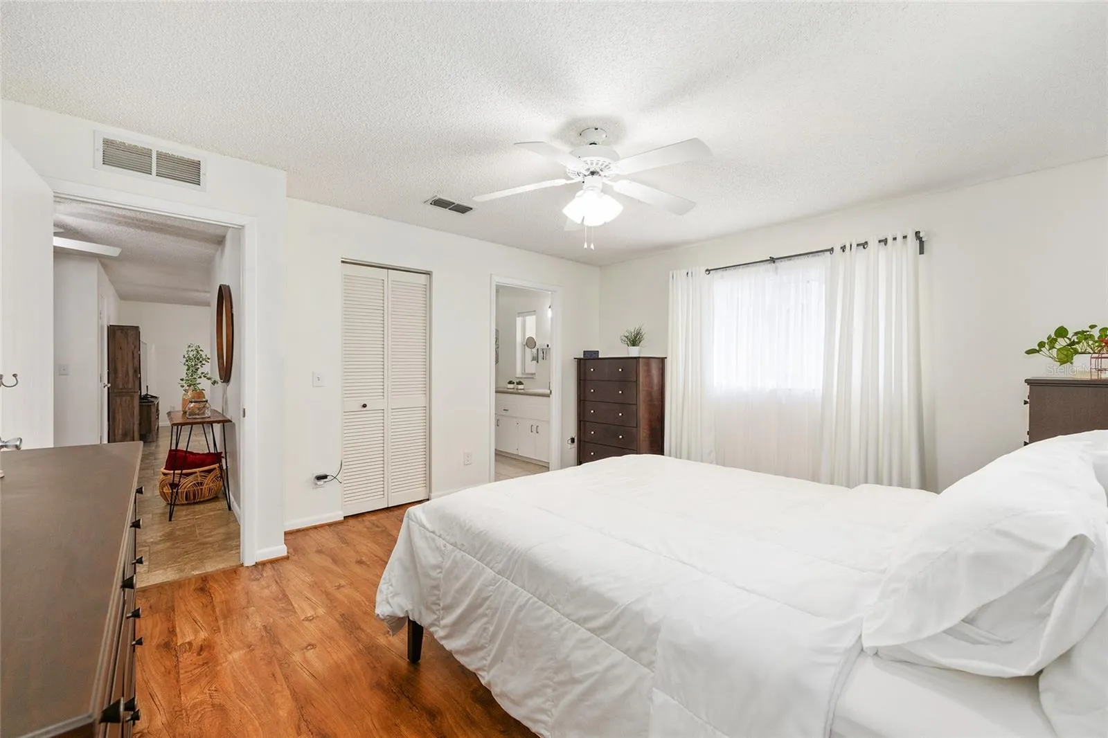 Primary bedroom features a walk-in closet and private ensuite bath for added comfort and convenience.