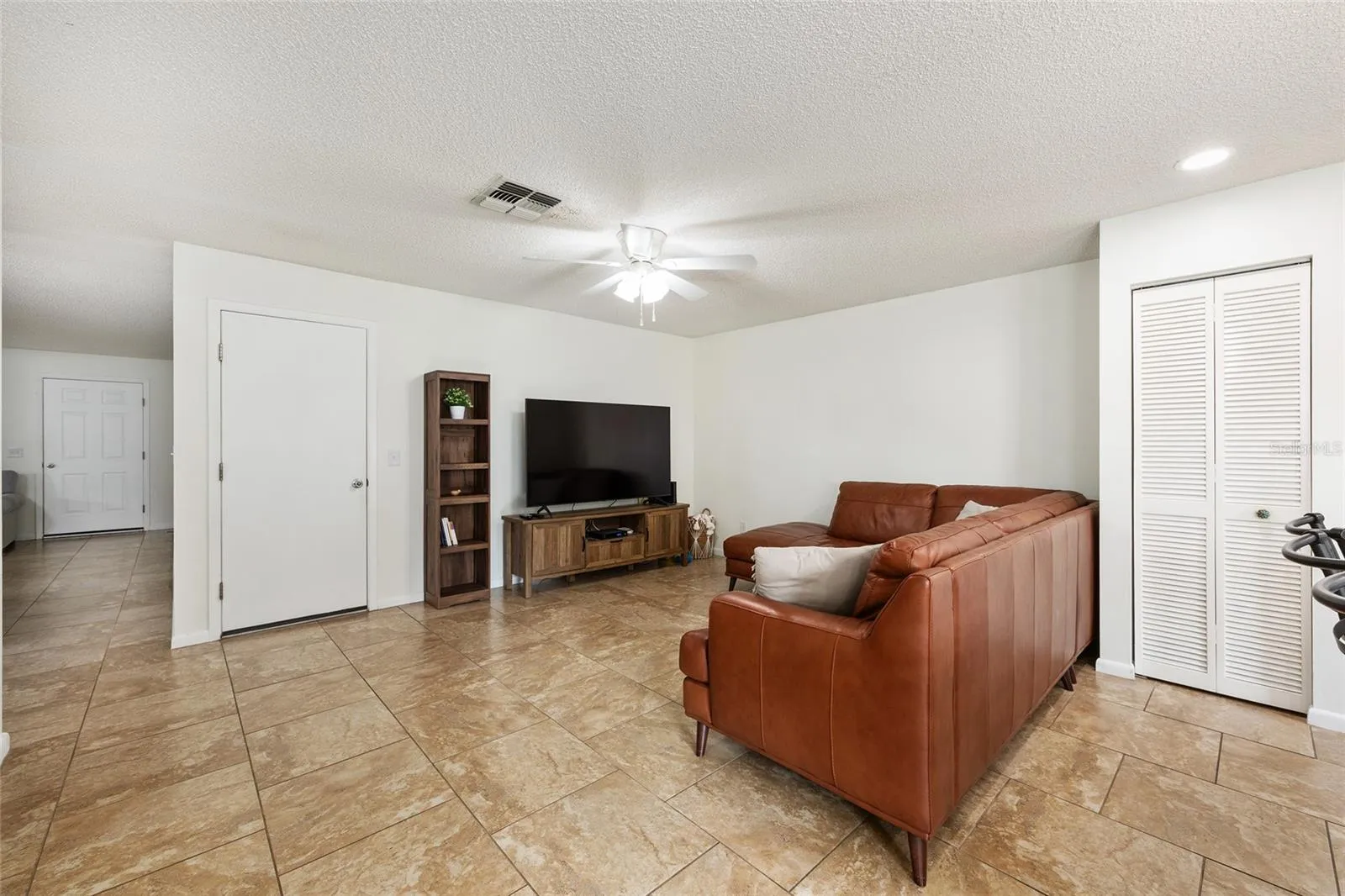 Family room offers a comfortable space to relax and enjoy the open connection to the kitchen.