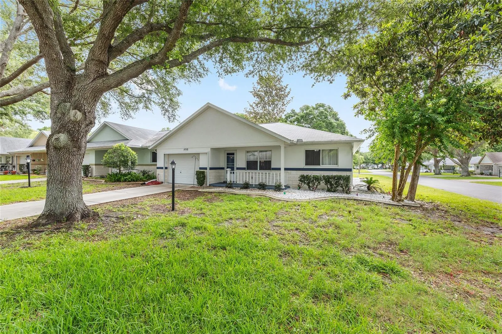 Long driveway and 1.5-car garage enhance the convenience and appeal of this desirable end-unit villa.