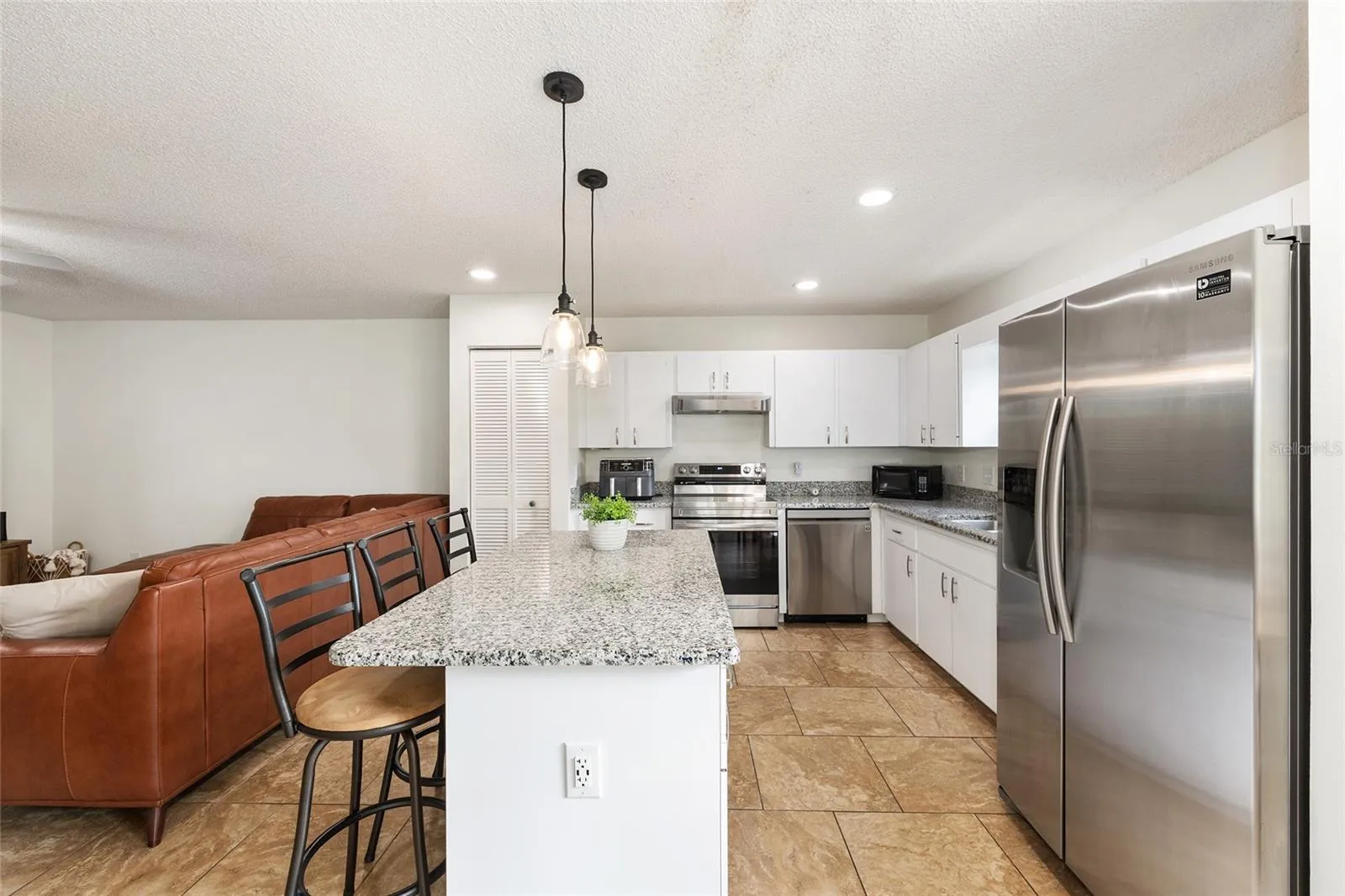 Kitchen opens to the family room and eat-in breakfast nook area, creating a comfortable and connected living space.