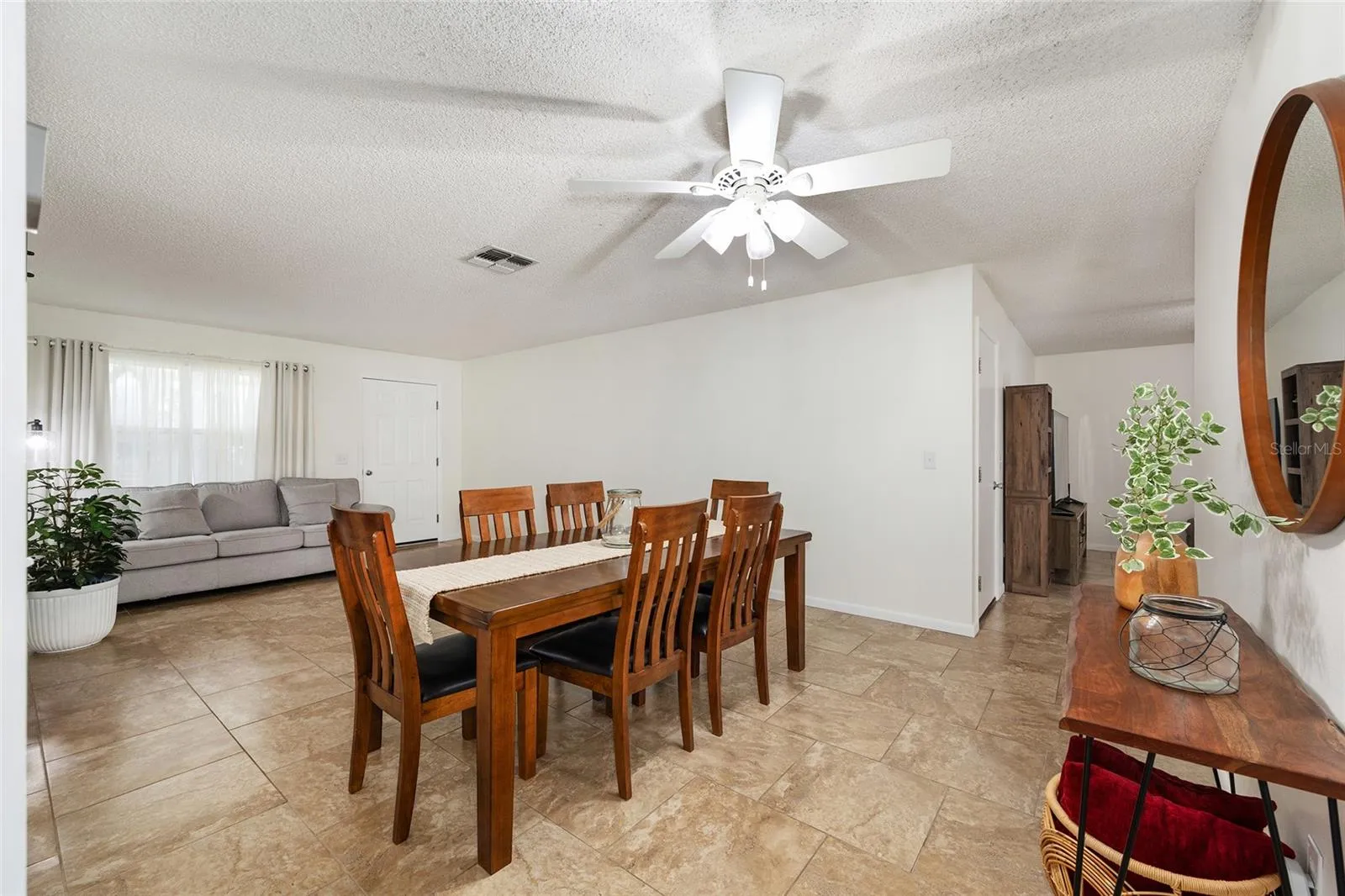 View of the dining room/living room combination from the primary bedroom, highlighting the open and connected layout