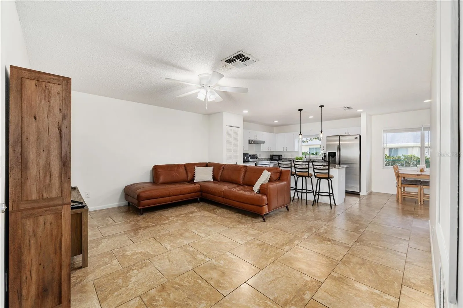 Another view of the family room/kitchen combination from the garage entry, highlighting the open and functional layout.