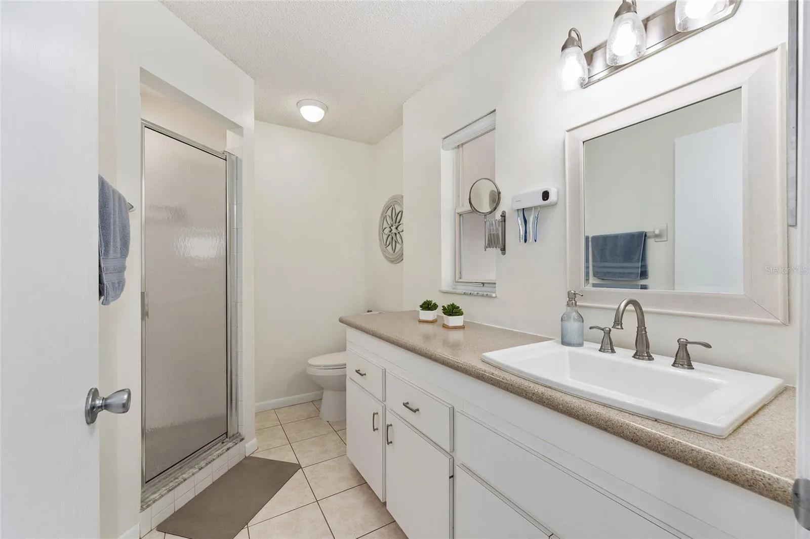 Primary bathroom offers a functional layout with convenient access from the primary bedroom.