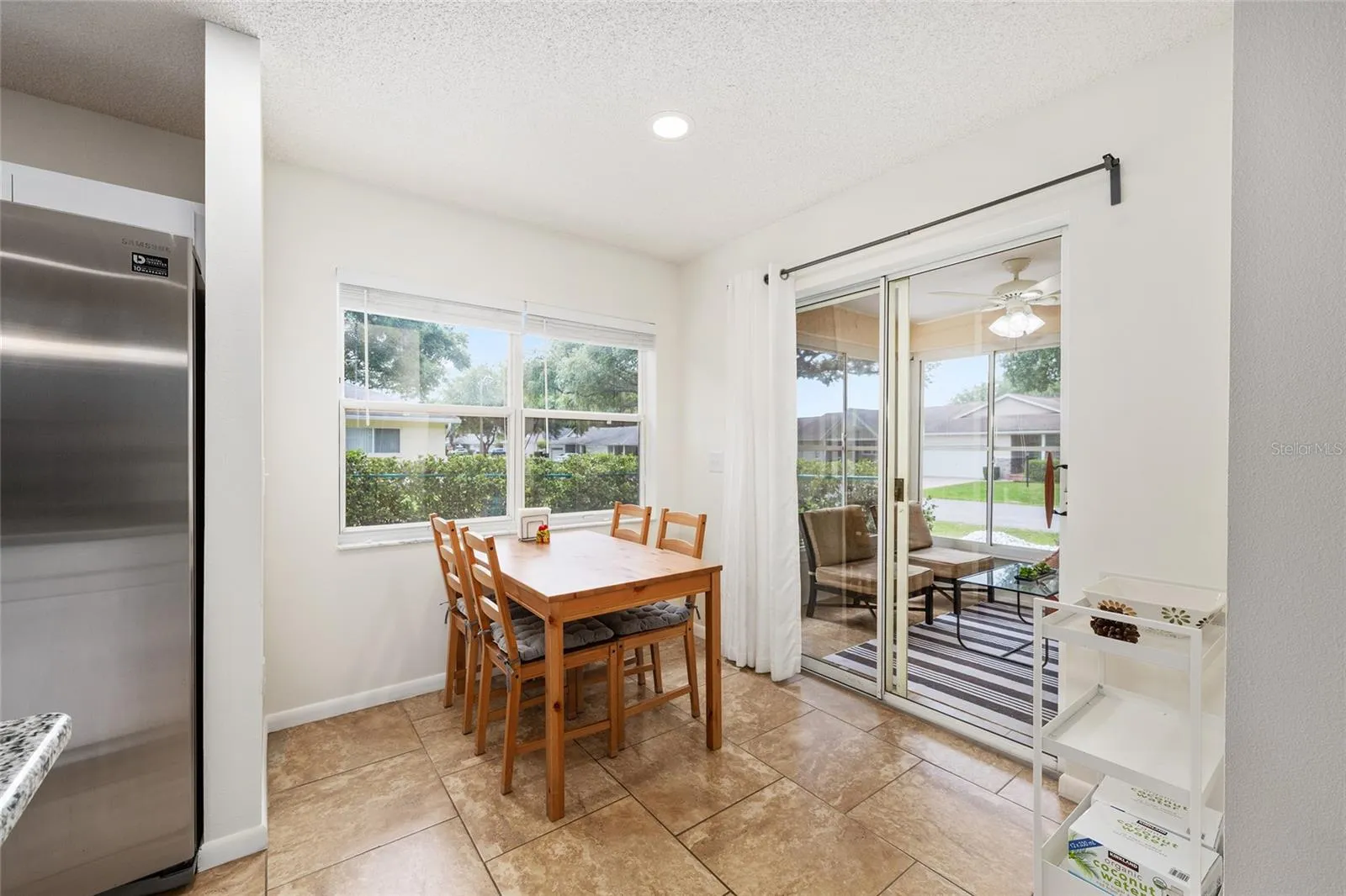 Breakfast nook area off the kitchen offers a bright, casual dining space with access to the enclosed lanai.
