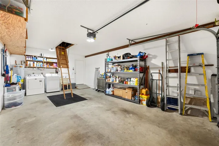 1.5-car garage includes washer and dryer, plenty of storage space, and a drop-down attic ladder for additional storage.