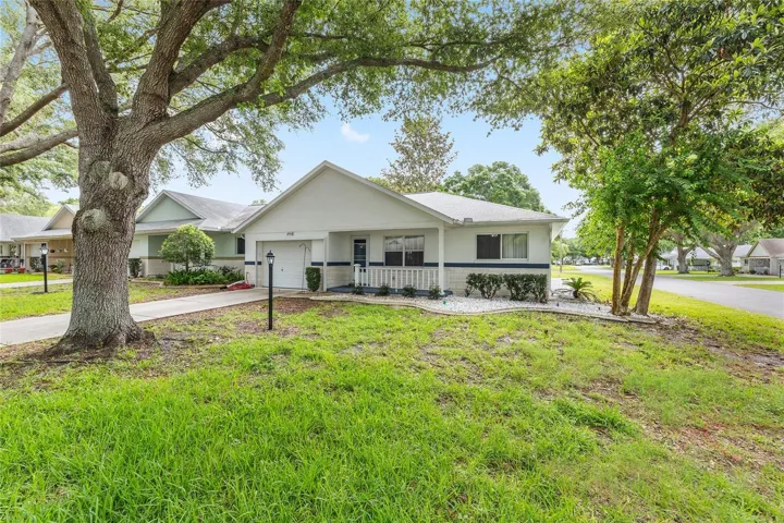 Long driveway and 1.5-car garage enhance the convenience and appeal of this desirable end-unit villa.
