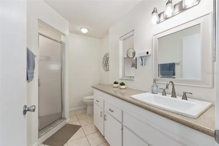 Primary bathroom offers a functional layout with convenient access from the primary bedroom.