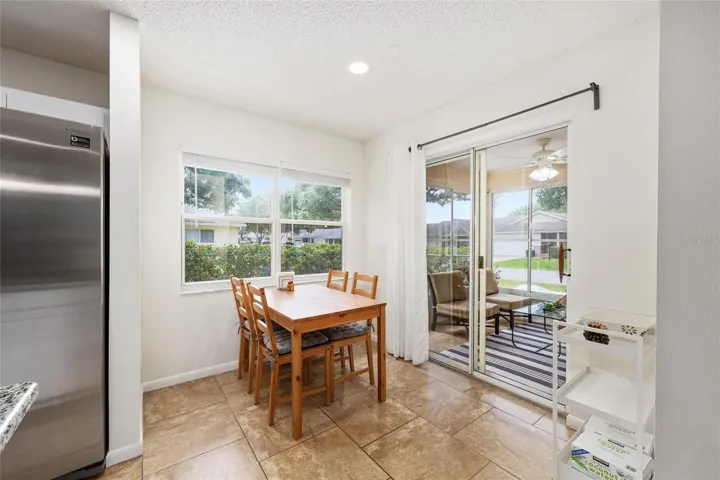 Breakfast nook area off the kitchen offers a bright, casual dining space with access to the enclosed lanai.