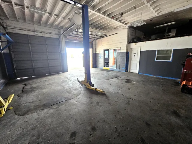 Main bays with dual 10'x10' overhead doors. Automotive lift not included