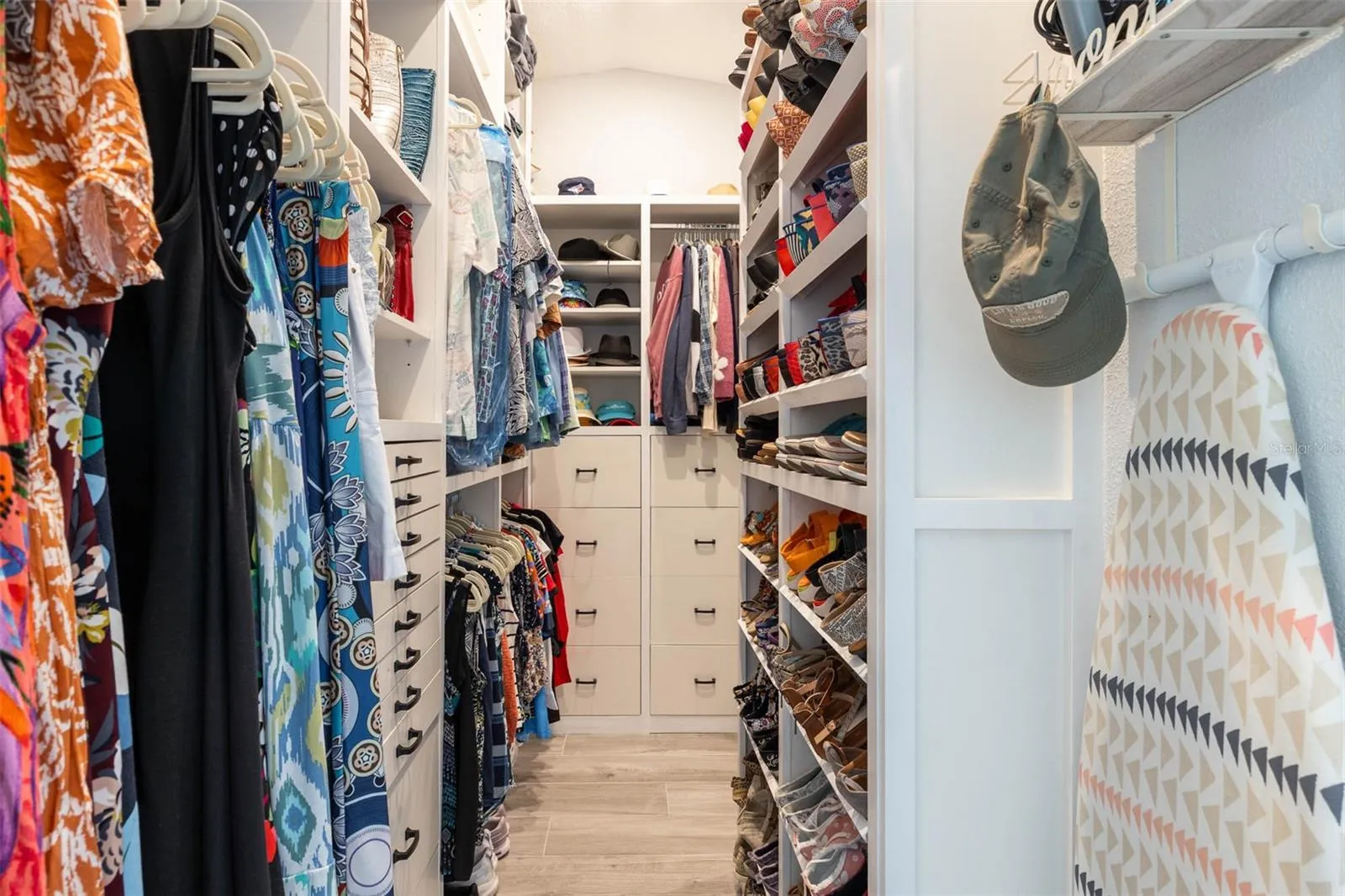 Primary Suite Closet.   Custom closet organizer runs floor to ceiling to maximize storage options.