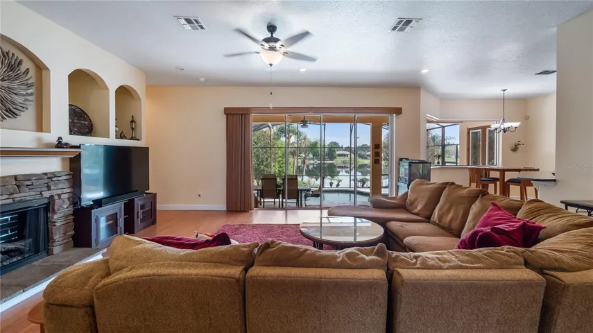 View from walking in front door to see great room to back patio/pool/lake Katherine