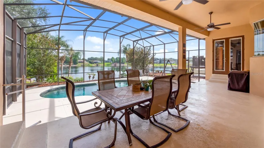 Rear patio off of great room. Double glass door access to primary bedroom on one side and second bedroom on this side.