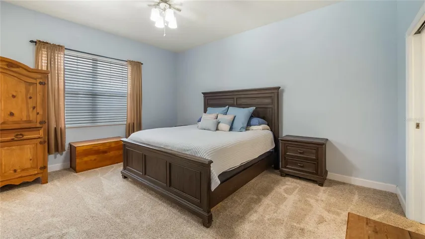 Primary bedroom with double glass doors out to rear patio/pool