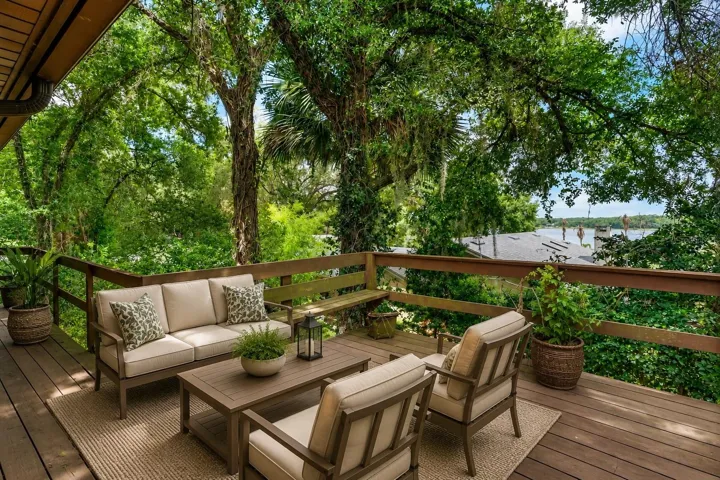 Walk around balcony of back of home with lake views.