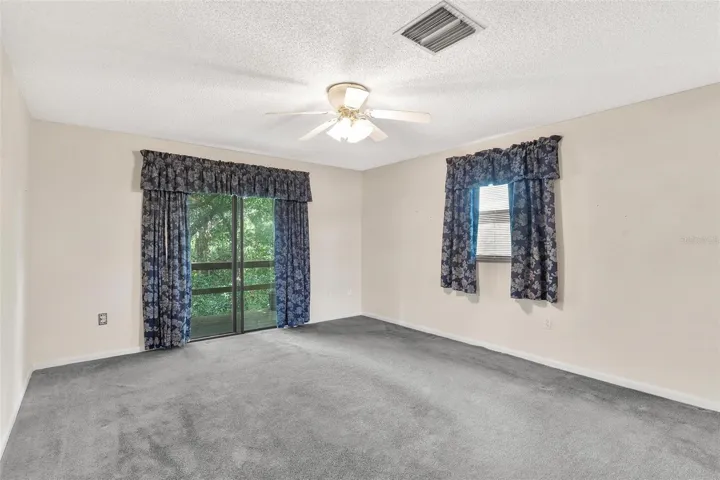 Primary Bedroom with sliders leading to balcony