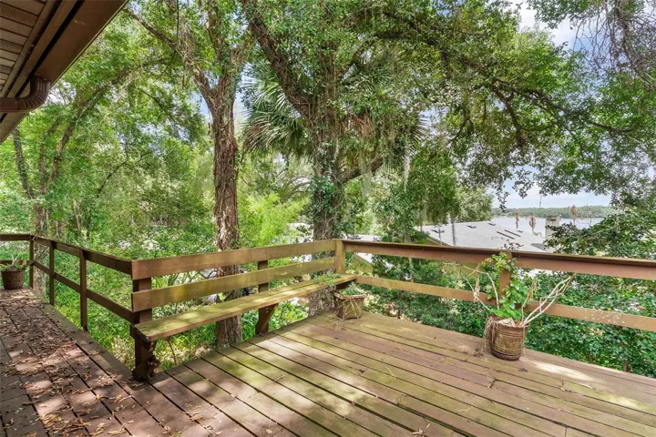 Walk around balcony of back of home with lake views.