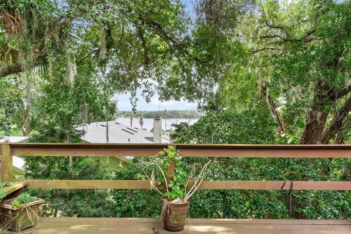 Walk around balcony of back of home with lake views.