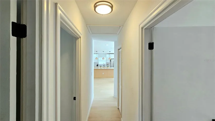 Cell Phone photo. Master Suite 2 is located through the right door. Bedroom 4 is located directly across. Bedroom 3 is also located on left. Bath 2 is located at end of hallway on right.