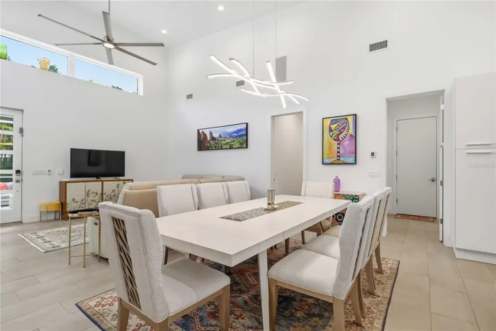 Living / Dining Area showing entrance to Laundry / Powder Bath / Garage and hallway to guest bedrooms and bathroom