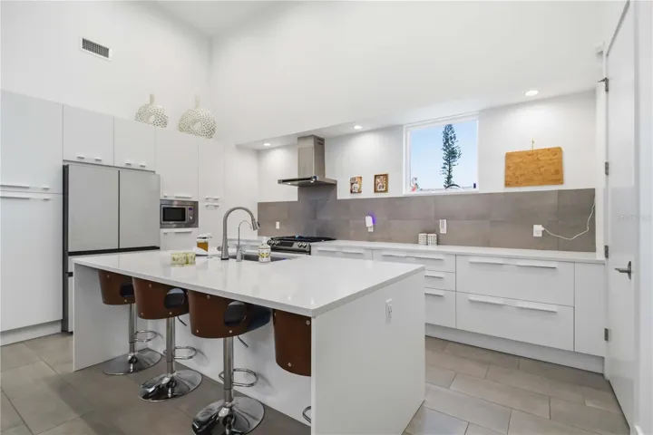European Matte Acrylic Cabinets and tons of storage in this kitchen