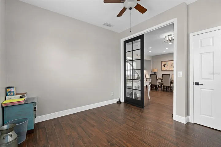 bedroom 5 downstairs but also could be used as an office/den/flex space with double doors