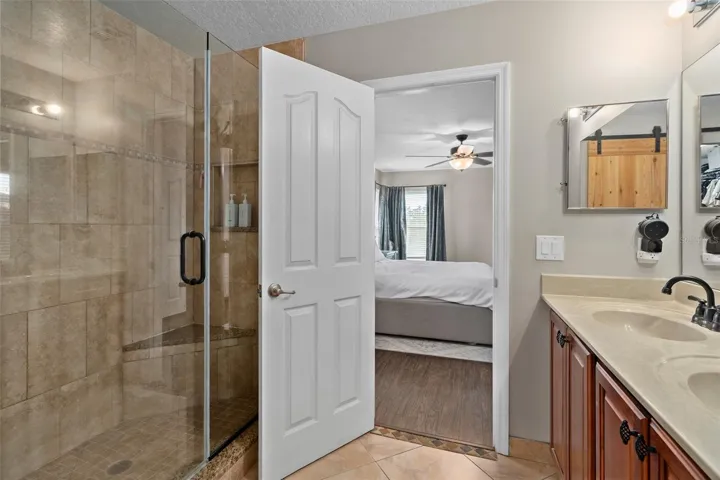 master bathroom with walk in shower with frameless glass.