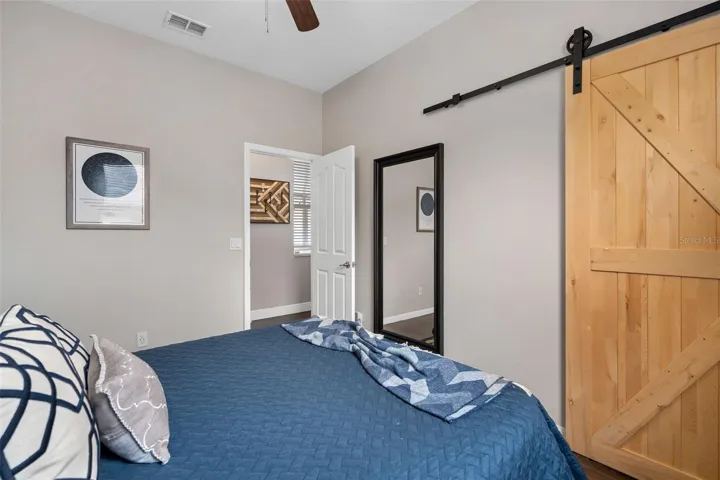 downstairs bedroom 2 with barn door to closet