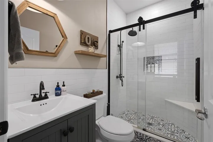 downstairs bathroom 2 completely remodeled with custom tile work, shower bench and a frameless shower door. Might be the only house with a full third bathroom in this floor plan.
