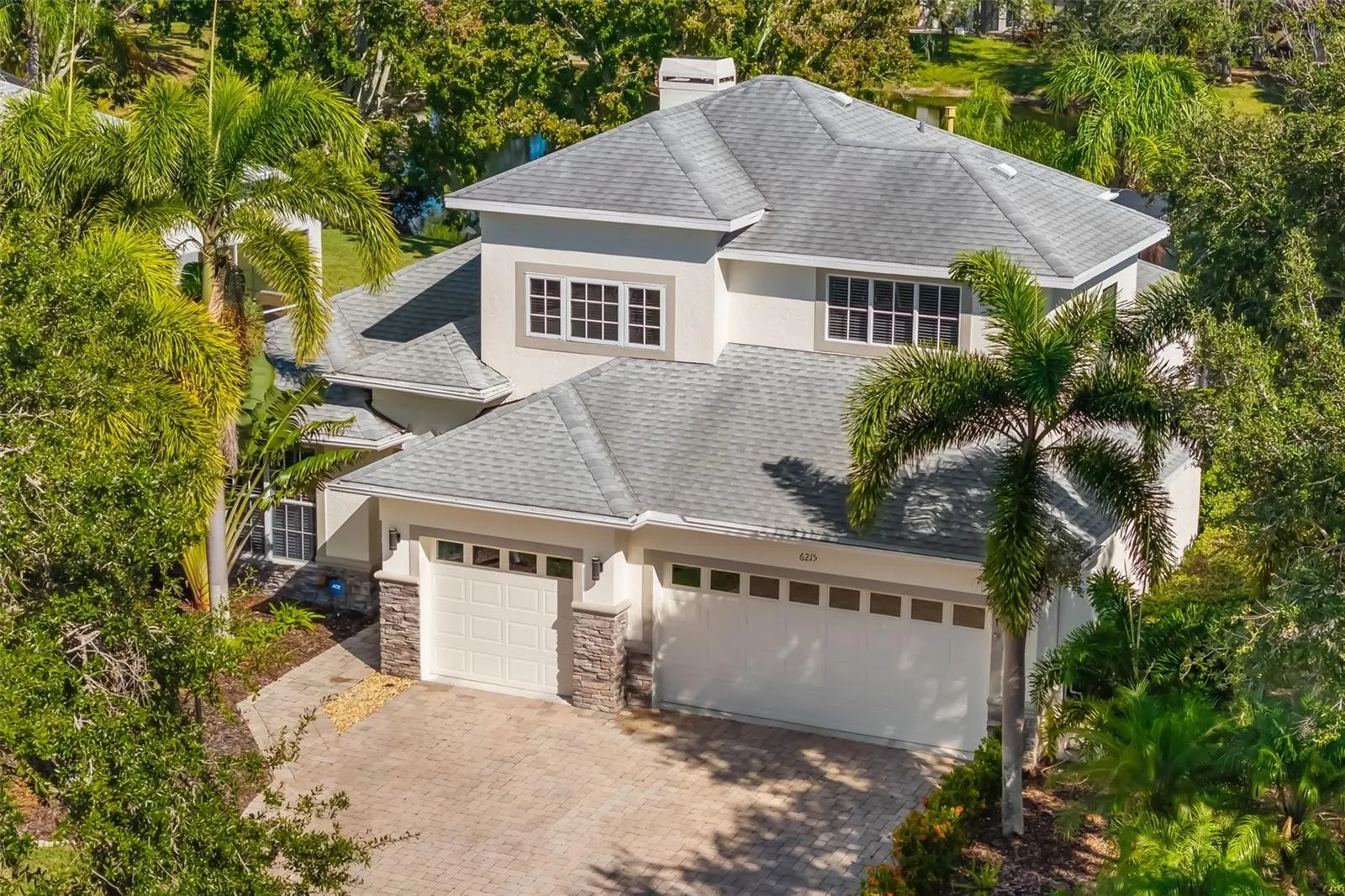 Beautiful Well Landscaped Palm Tree Home on Lake.
