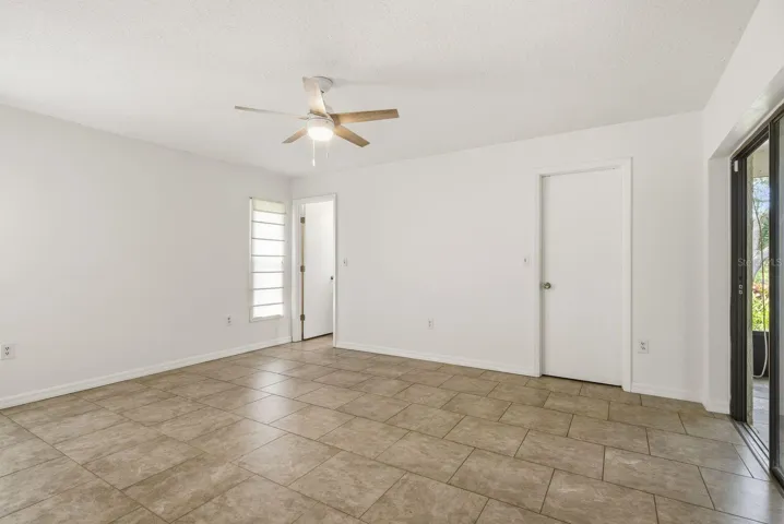 Primary bedroom, primary bathroom, walk in closet & sliders to exterior patio