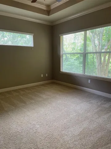 MASTER BEDROOM WITH TRAY CEILING AND TONS OF LIGHT