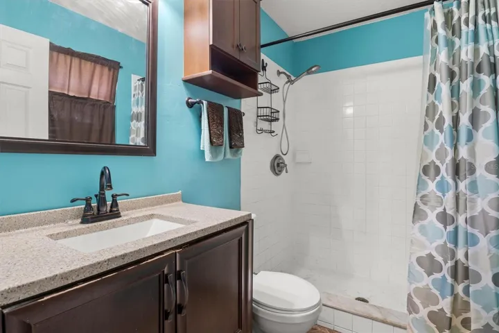 Primary bathroom, granite counter top, tile shower