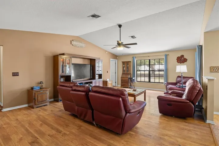 living room, door way on the left is primary bedroom. Sliding doors on the right lead to back patio