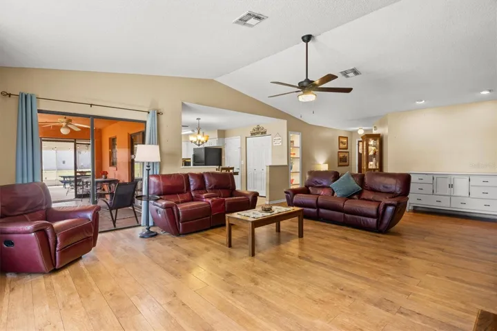living room view towards kitchen. Sliding doors lead to back patio.