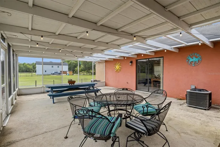 additional covered back patio, one of the entryways to the bonus room from this location