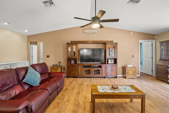 living room, door on the right is primary bedroom. Hallway to the left leads to two bedrooms and bathroom